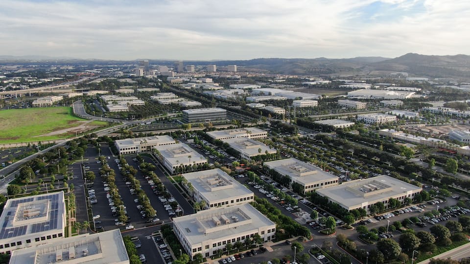 Aerial view of business and finance district with new office building surrounded by parking and road. Irvine Business Complex. Irvine California. USA