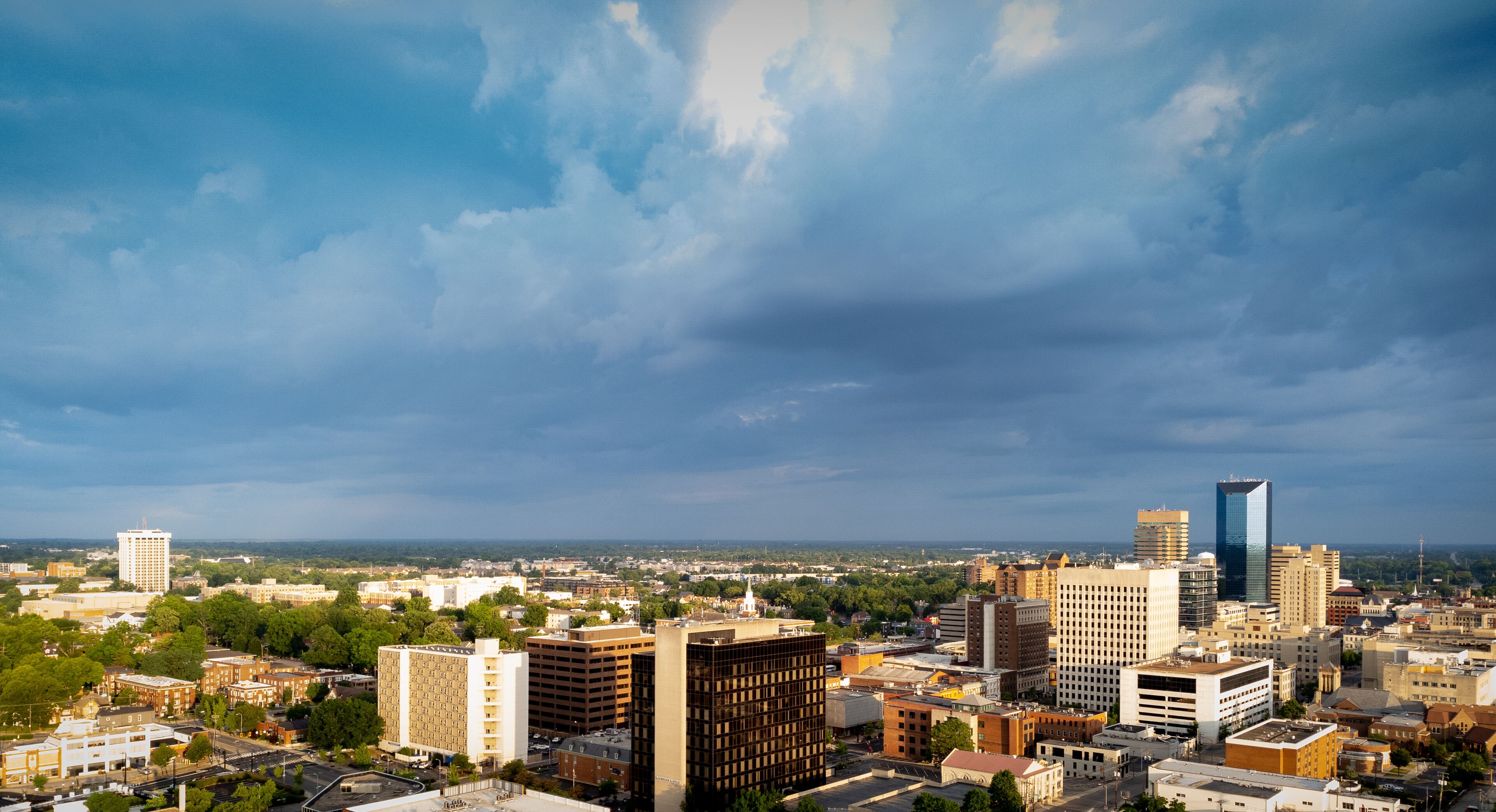 Aerial view of downtown Lexington, Kentucky. Tall buildings of financial business offices on the right side. Local university campus and administrative building on the left.