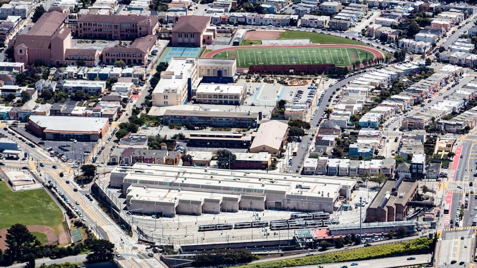 Aerial View of a Local High School and an Athletic Field in a Neighborhood in South San Francisco, California, USA