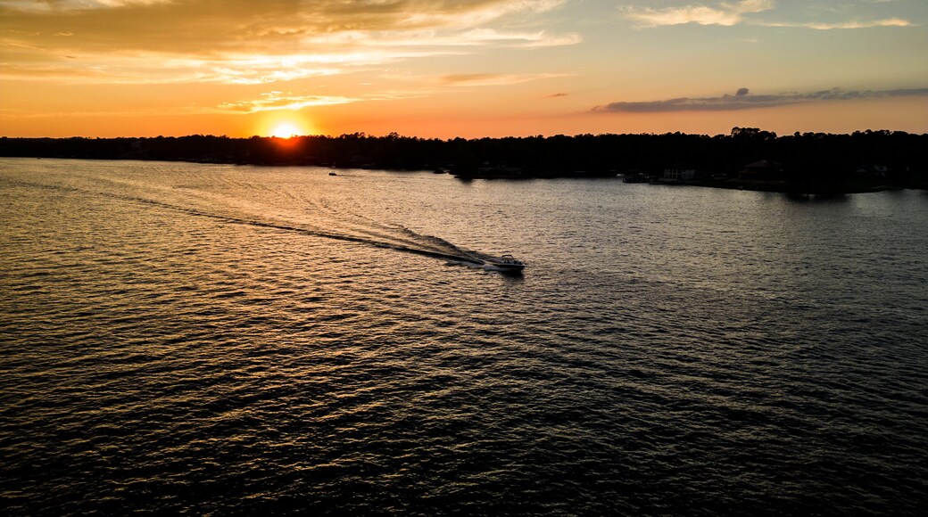 Boat cruising on lake during summer sunset