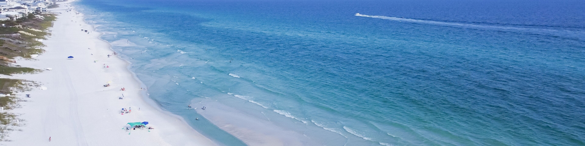 Miles of untouched beaches brilliantly white sand, crystal clear turquoise water with gorgeous shade of blue along upscale residential waterfront neighborhood in Santa Rosa, Florida, USA