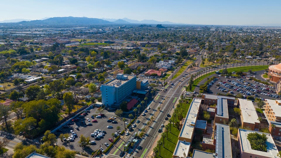 Arizona State University ASU main campus aerial view on Apache Boulevard with South Mountain at the background in city of Tempe, Arizona AZ, USA.