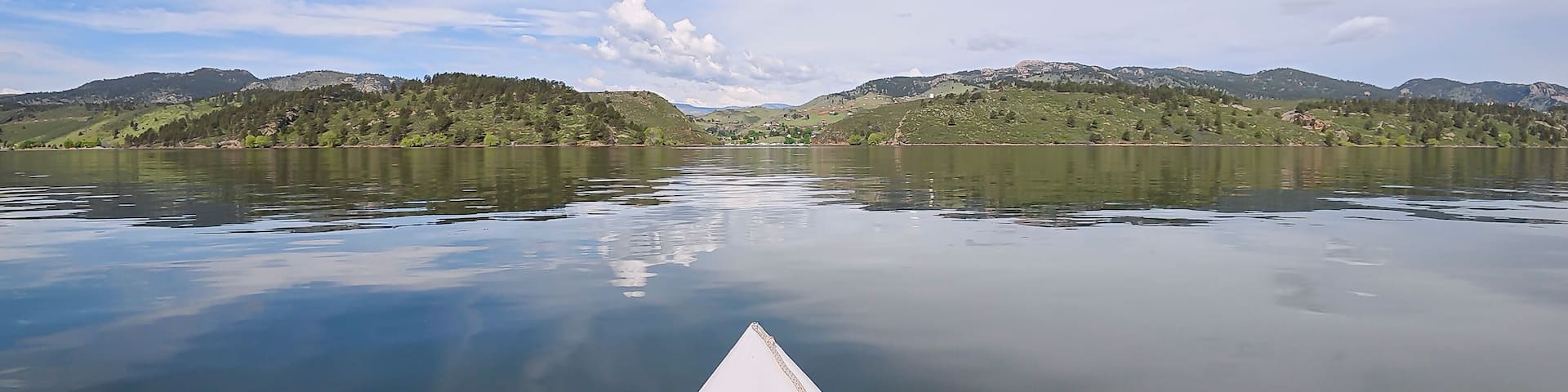 spring kayaking or canoeing on Horsetooth Reservoir at foothills of Rocky Mountains near Fort Collins, Colorado - POV paddler perspective