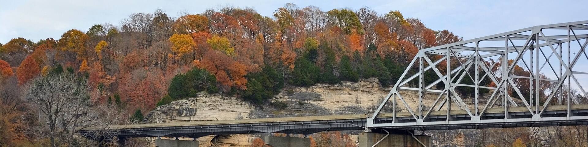 Highway Truss Bridge Over a River with Bluffs and Colorful Fall
