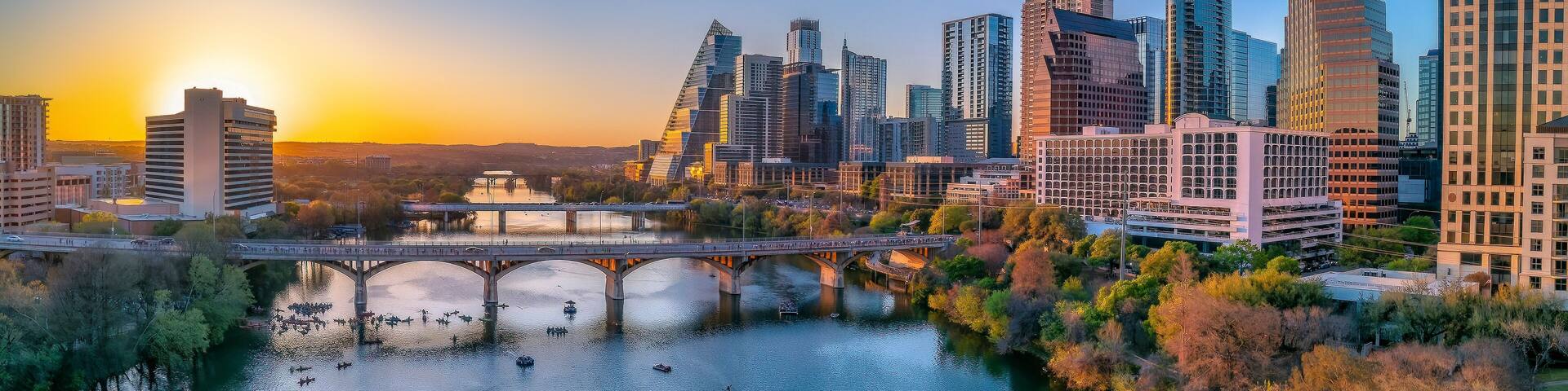 Austin, Texas- Cityscape with Colorado River in the middle against the sunset sky