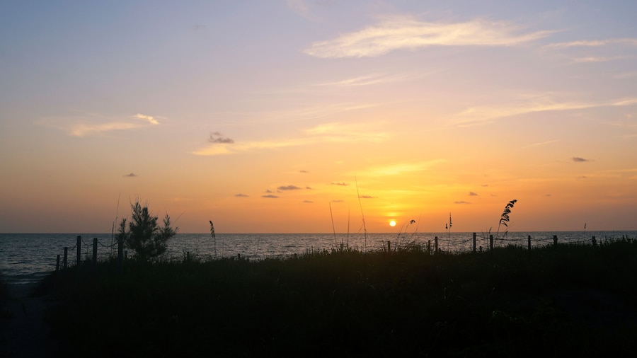 Sunset in Captiva Sanibel Island, Florida. Gulf of Mexico at dusk. Sun sets over beach on Captiva Island over calm waters. Illuminated dreamy summer sunset.