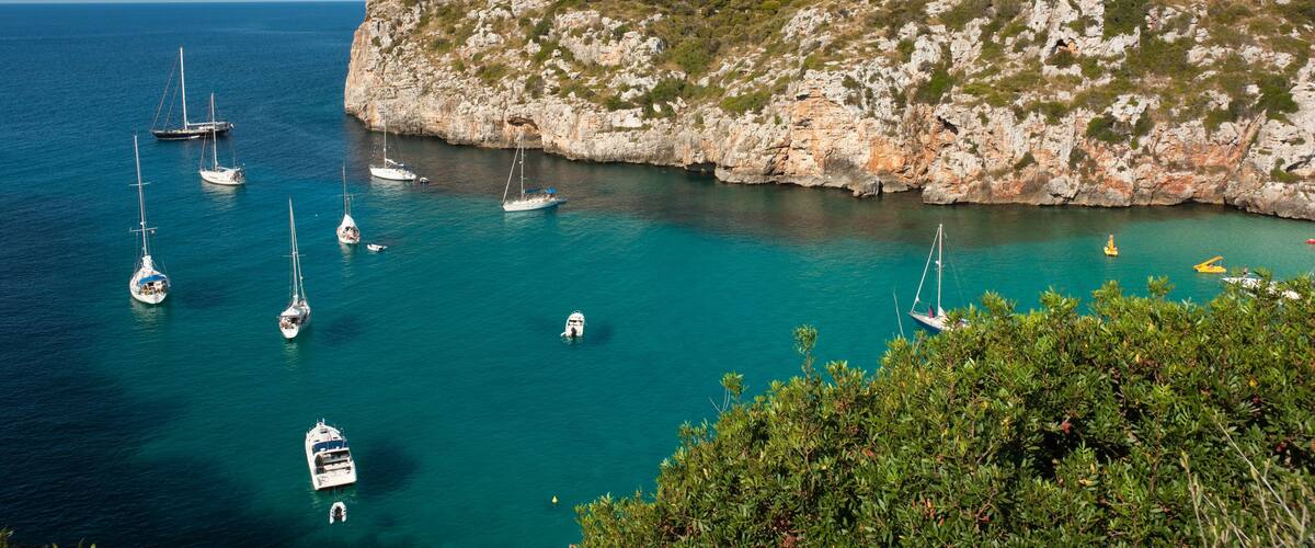 Landscape of Cala En Porter, Menorca, detailing the cliffs and several boats, Shutterstock ID 36918535, Purchase Order: -