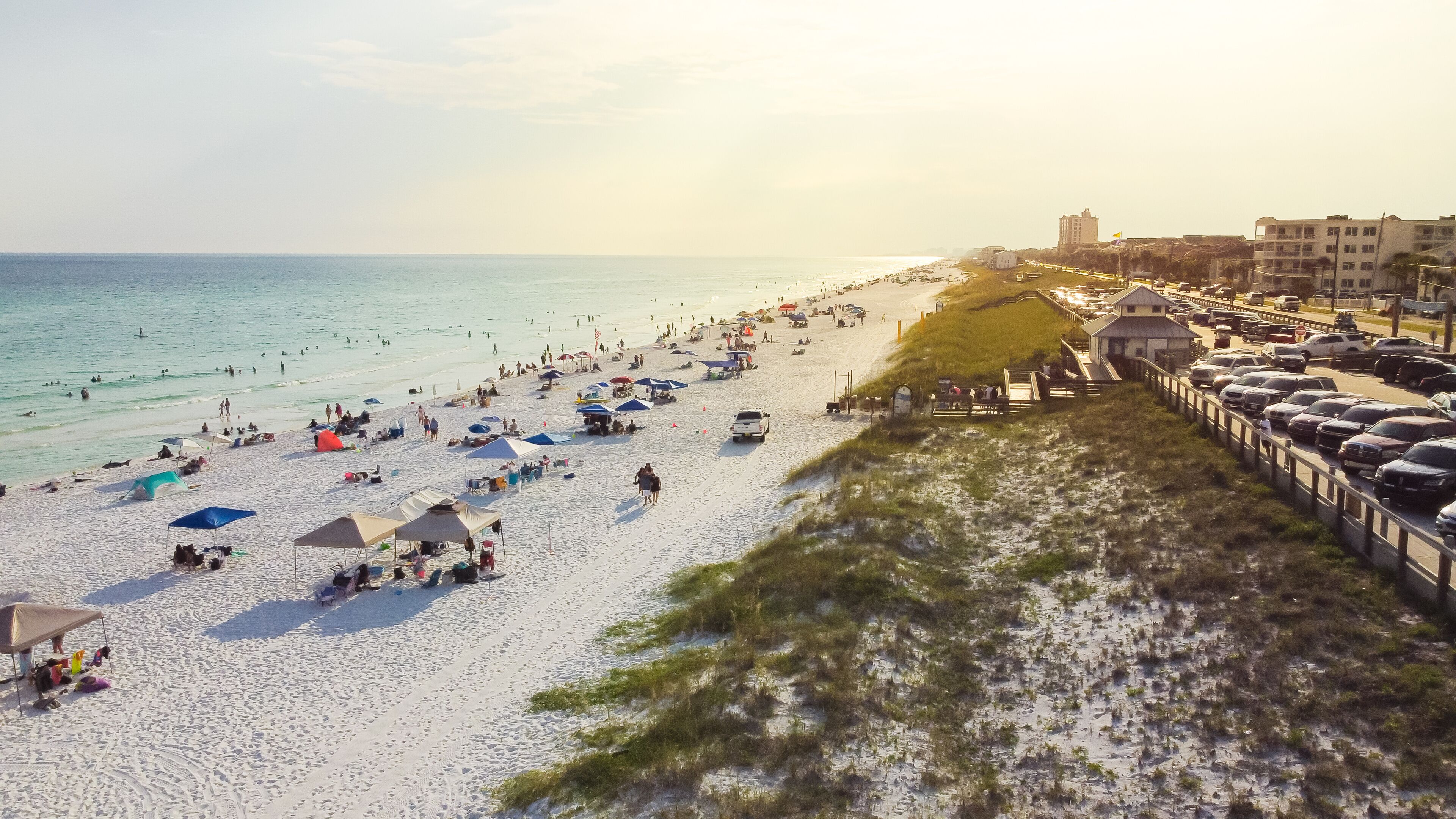 Public parking and access entrance to miles of white sandy beaches, clean turquoise water Miramar Beach east South Walton, Destin, Florida, USA crowed people relaxing, swimming, laid-back