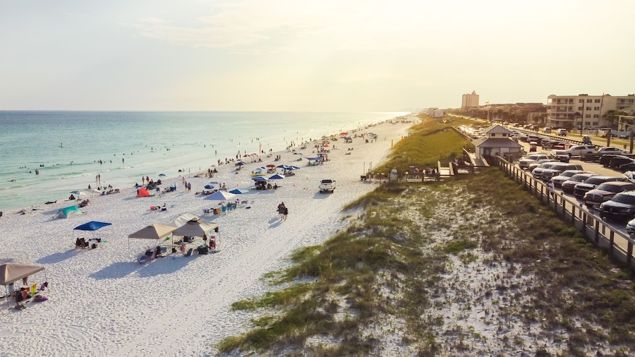 Public parking and access entrance to miles of white sandy beaches, clean turquoise water Miramar Beach east South Walton, Destin, Florida, USA crowed people relaxing, swimming, laid-back