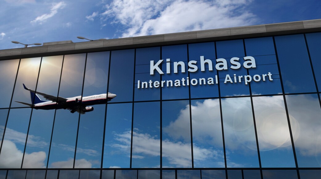 Airplane landing at Kinshasa Congo airport mirrored in terminal