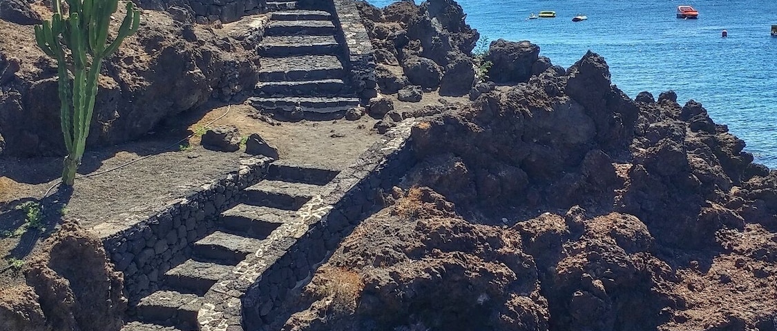 Puerto del Carmen is a resort town on the southeast coast of the Spanish island of Lanzarote. It’s home to beaches such as sandy Playa Grande and Matagorda, which is known for its steady breeze. Fishing boats cluster at the old town dock, El Varadero. Avenida de las Playas, a beachside boulevard, is lined with shops,restaurants and lively nightclubs. Just inland, Rancho Texas Lanzarote Park has a zoo. Google