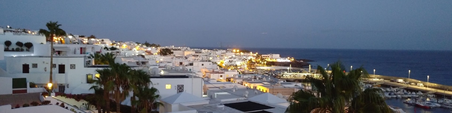 Puerto del Carmen is a resort town on the southeast coast of the Spanish island of Lanzarote. It’s home to beaches such as sandy Playa Grande and Matagorda, which is known for its steady breeze. Fishing boats cluster at the old town dock, El Varadero. Avenida de las Playas, a beachside boulevard, is lined with shops,restaurants and lively nightclubs. Just inland, Rancho Texas Lanzarote Park has a zoo. Wikipedia