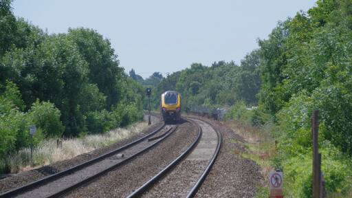 CrossCountry class 220 "Voyager" DEMU 220011 speeds west, away from Nailsea & Backwell railway station.