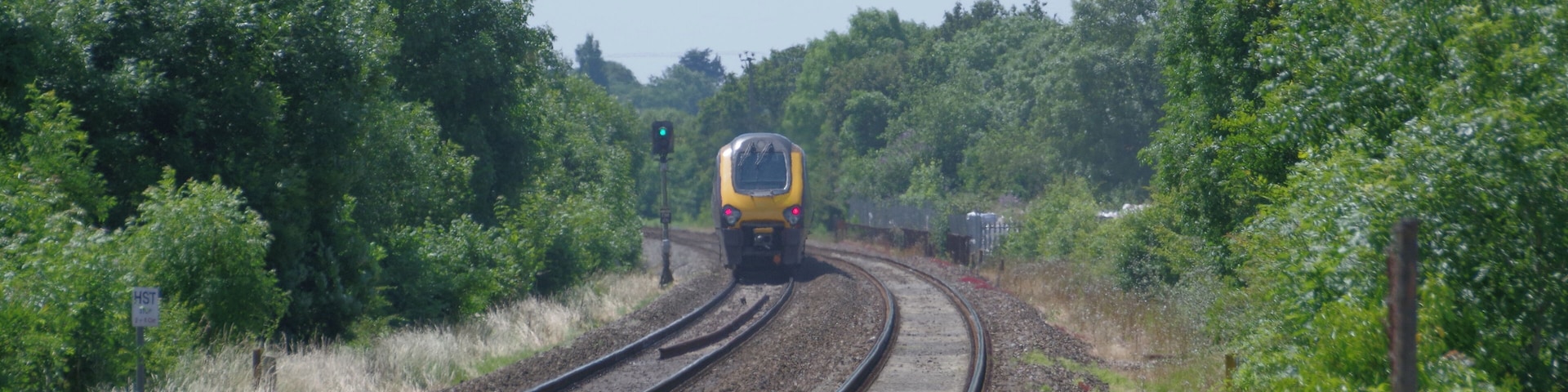 CrossCountry class 220 "Voyager" DEMU 220011 speeds west, away from Nailsea & Backwell railway station.