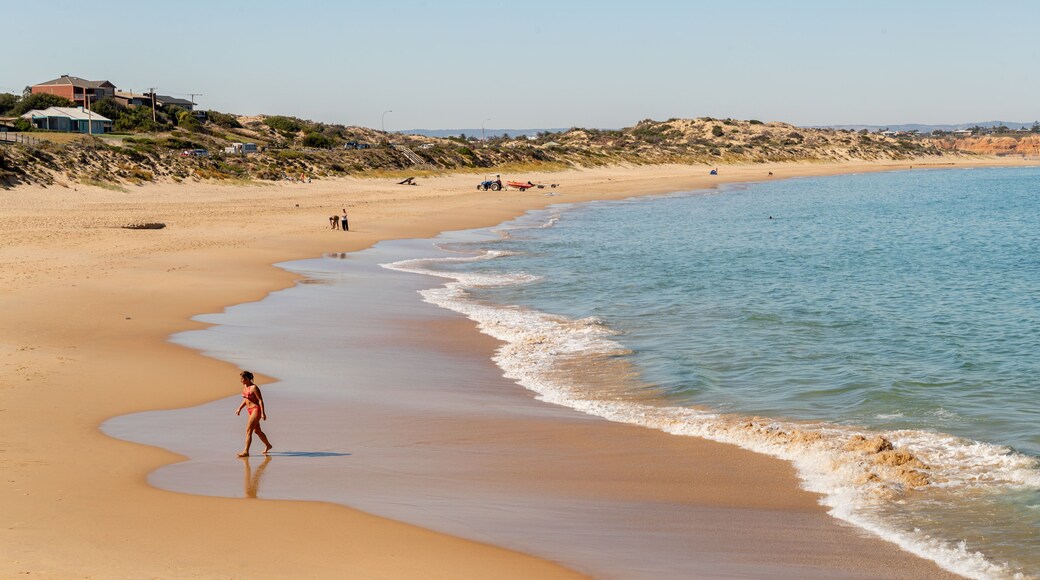 Port Noarlunga Beach featuring a sandy beach and general coastal views as well as an individual male