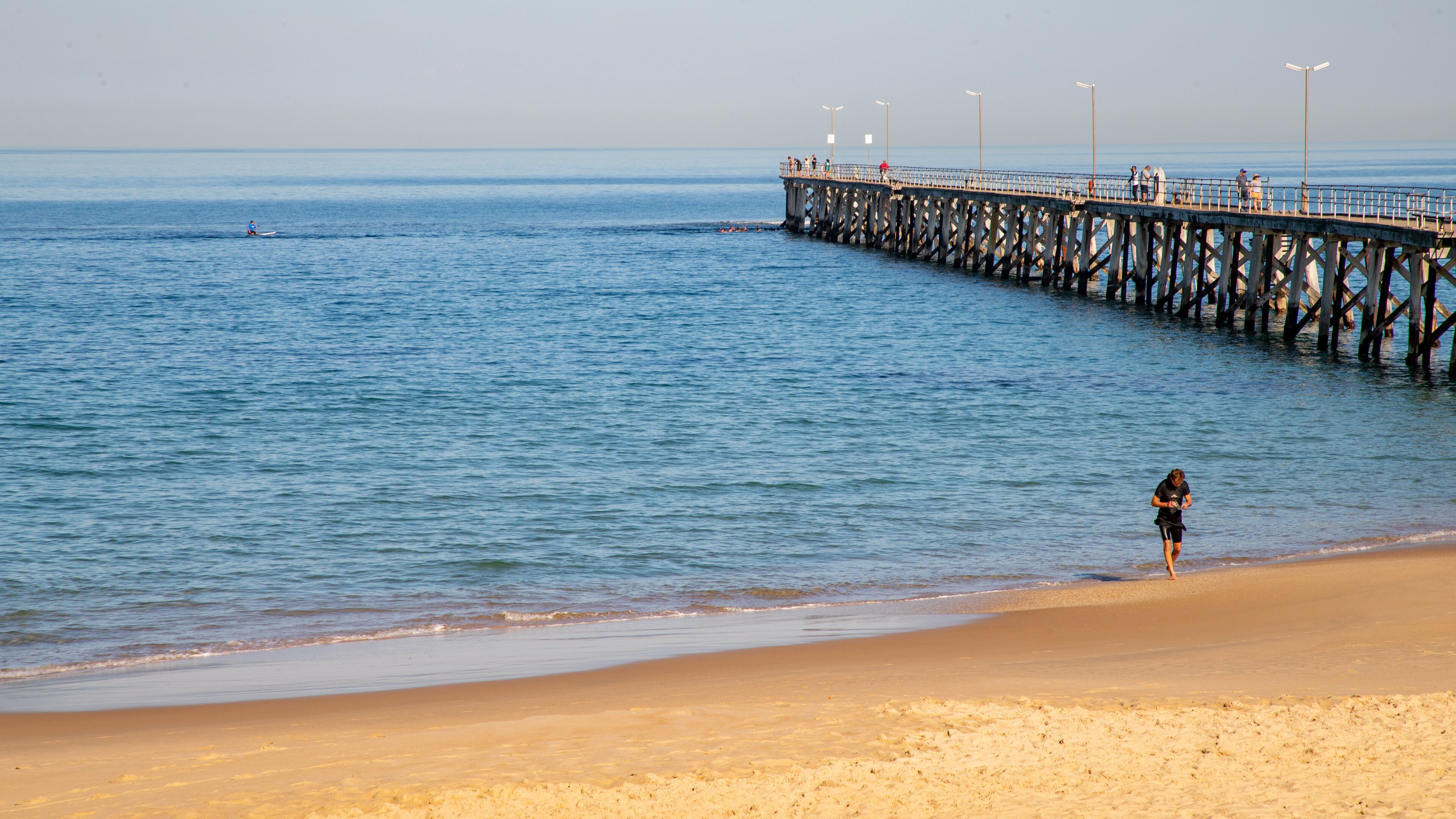 Port Noarlunga Jetty showing a sandy beach and general coastal views