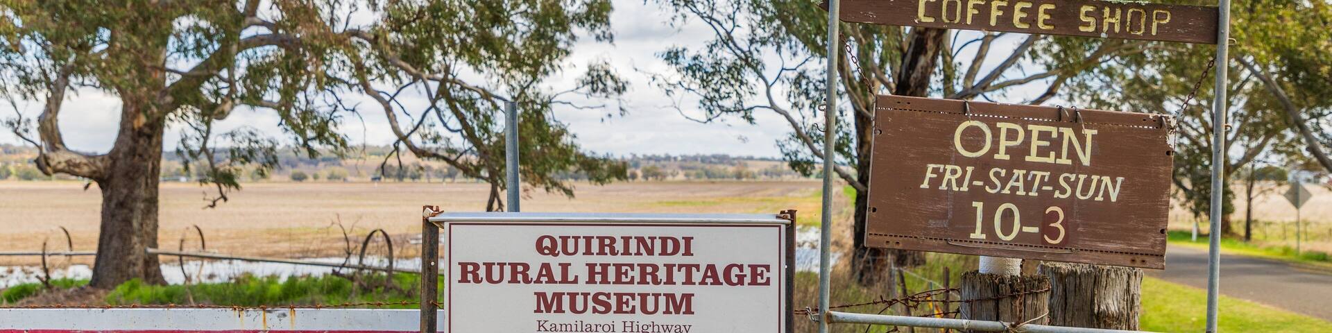 Signs for the Quirindi Rural Heritage Museum and a coffee shop.
