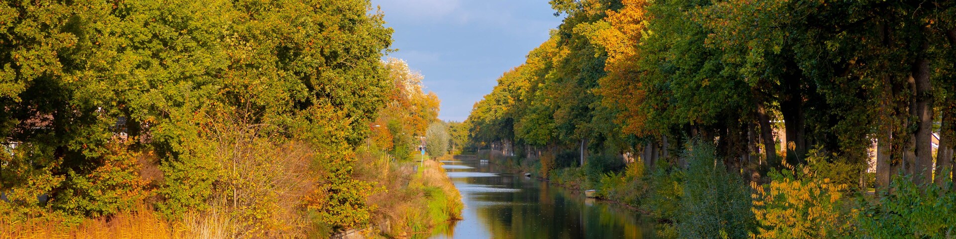 Oranjekanaal (Oranje Canal) with blue sky and colourful leaves on the tree in Autumn, Schoonoord is a small village in the Netherlands and it is part of the Coevorden municipality in Drenthe, Holland.