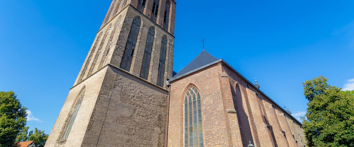 The Grote of Sint-Clemenskerk and tower under blue clear sky in summer, Protestant church in the Dutch city of Steenwijk, The main town of the municipality of Steenwijkerland, Overijssel, Netherlands.