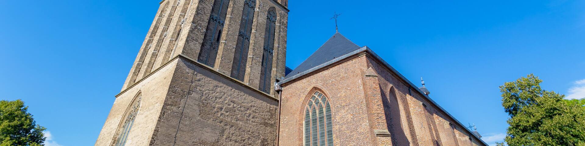 The Grote of Sint-Clemenskerk and tower under blue clear sky in summer, Protestant church in the Dutch city of Steenwijk, The main town of the municipality of Steenwijkerland, Overijssel, Netherlands.