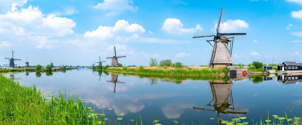 Panorama of the windmills and the reflection on water in Kinderdijk, a UNESCO World Heritage site in Rotterdam, Netherlands