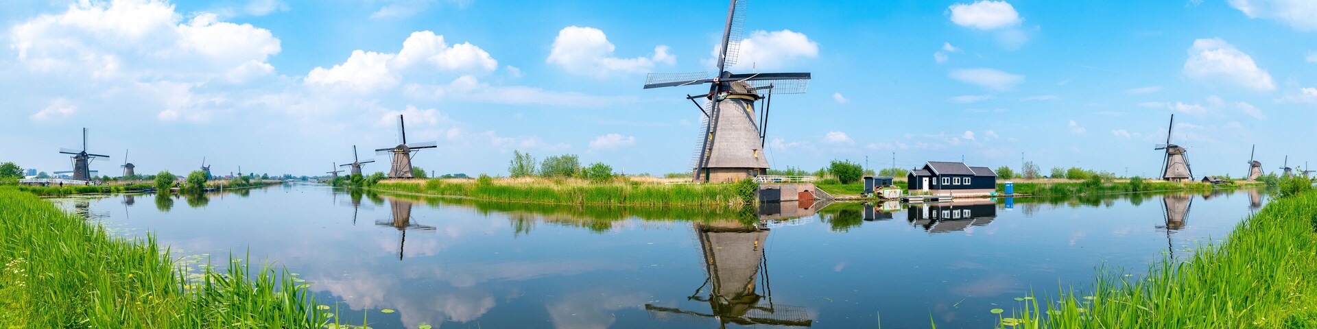 Panorama of the windmills and the reflection on water in Kinderdijk, a UNESCO World Heritage site in Rotterdam, Netherlands
