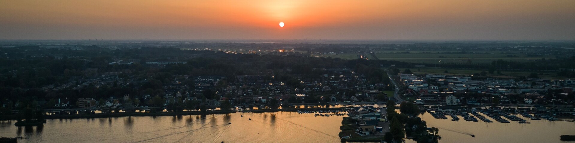 Sun sets on Elfhoeven Reeuwijkse Plassen wetland lake area of the Netherlands