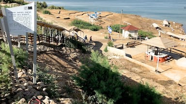 The Dead Sea is a salt lake bordered by Jordan and Israel. It lies in the Jordan Rift Valley, and its main tributary is the Jordan River.
Its surface and shores are 430.5 metres below sea level. Earth's lowest elevation on land. It is 304 m deep, the deepest hypersaline lake in the world. With a salinity of 342 g/kg, or 34.2%, it is one of the world's saltiest bodies of water – 9.6 times as salty as the ocean – and has a density of 1.24 kg/litre, which makes swimming similar to floating. This salinity makes for a harsh environment in which plants and animals cannot flourish, hence its name.