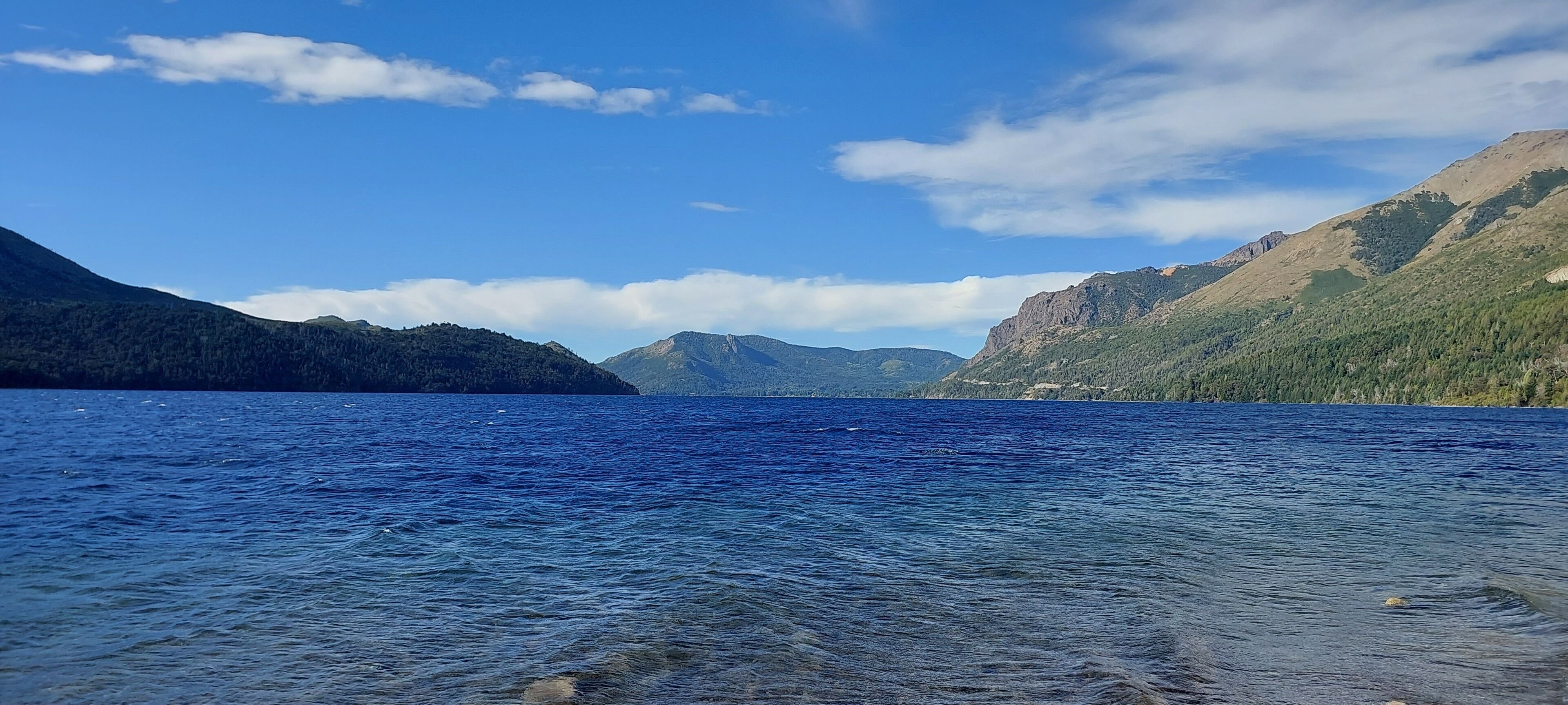 A clear lake surrounded by mountains.