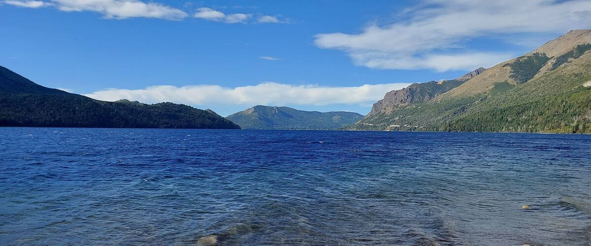 A clear lake surrounded by mountains.
