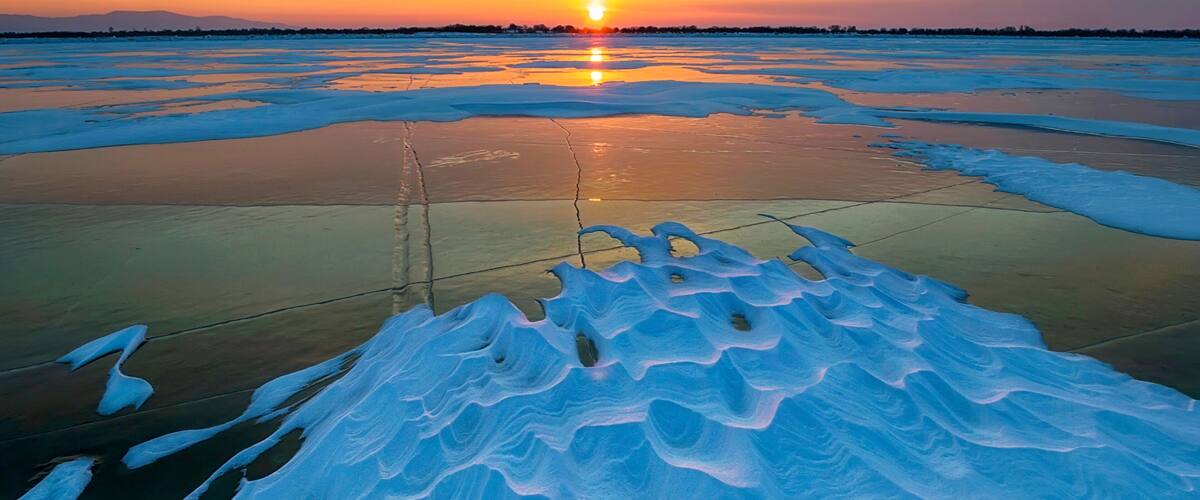 Frost and fire. Frozen Amur river at sunset. Khabarovsk Krai, far East, Russia.