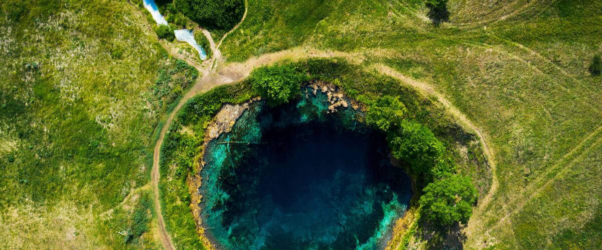 Aerial view from the drone of the landscape of blue mineral lake with clear water. Russia, Samara region, Blue lake.