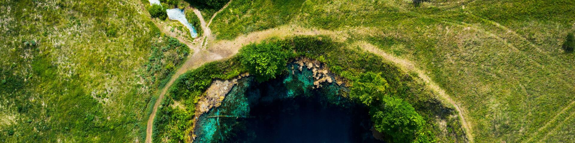 Aerial view from the drone of the landscape of blue mineral lake with clear water. Russia, Samara region, Blue lake.