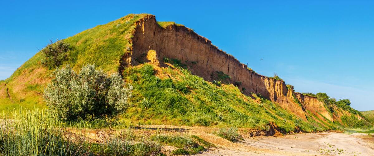 The hill with the landslip side on the seashore. Russia, Azov sea, Taganrog bay