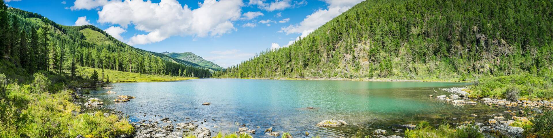 Panoramic view on mountain lake in front of mountain range, national park in Altai republic, Siberia, Russia