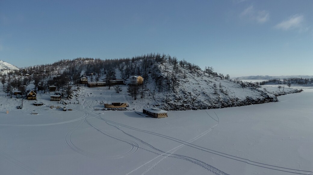 Beautiful landscape of winter snow-covered Lake Baikal and the surrounding mountains. Bird's-eye view