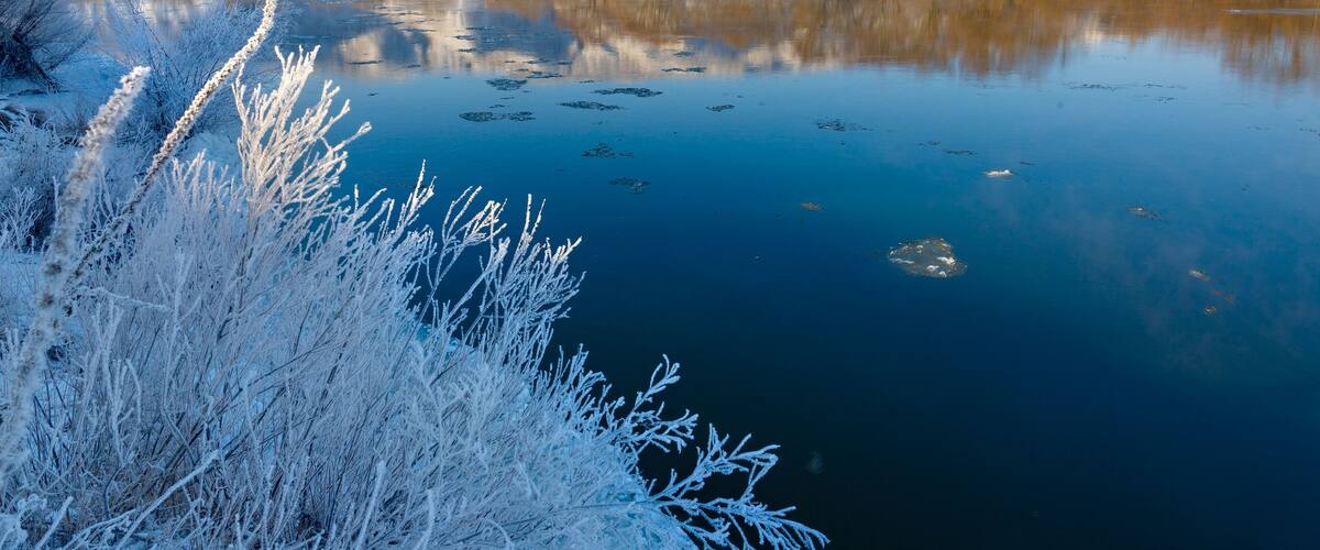 Freezing river from the hilly banks and large ice floes.