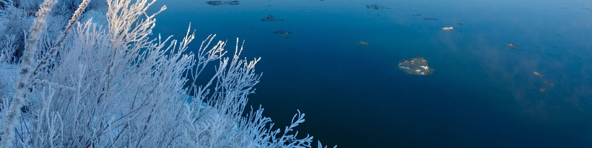 Freezing river from the hilly banks and large ice floes.