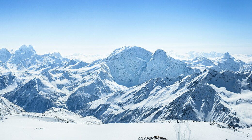 Snowy Greater Caucasus ridge with the Mt. Ushba at winter sunny day. View from Pastuchova kliffs at Elbrus ski slope, Kabardino-Balkaria, Russia