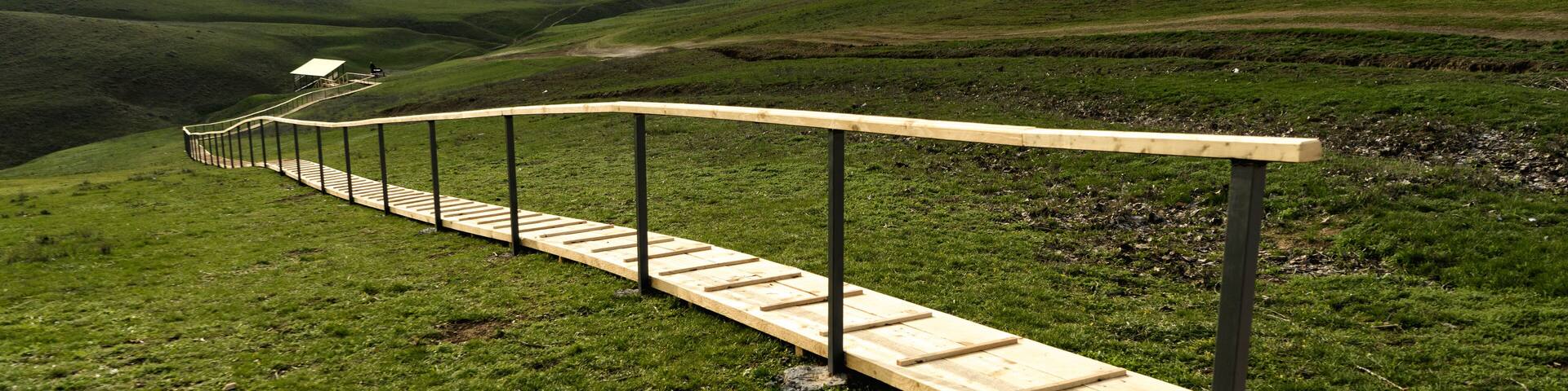 Wooden platform on a high hill in the steppes of Kalmykia. Spring landscape. Travels in Russia