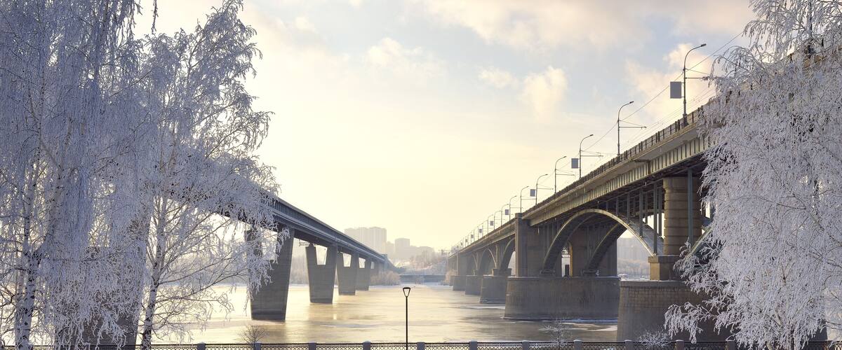 Michael's embankment in winter. Oktyabrsky bridge and metro bridge across the Ob lead to the Gorsky district