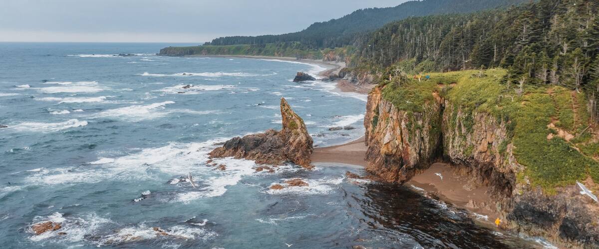 Picturesque Cape Velikan on the shore of the Sea of Okhotsk in the Far East of Russia, Sakhalin Island. Picturesque coastal cliffs and the sea.