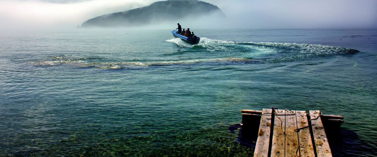 Crossing on a motor boat through a gulf on Petrov's island from coast of Lazovsky reserve. Primorski Territory. Russia.