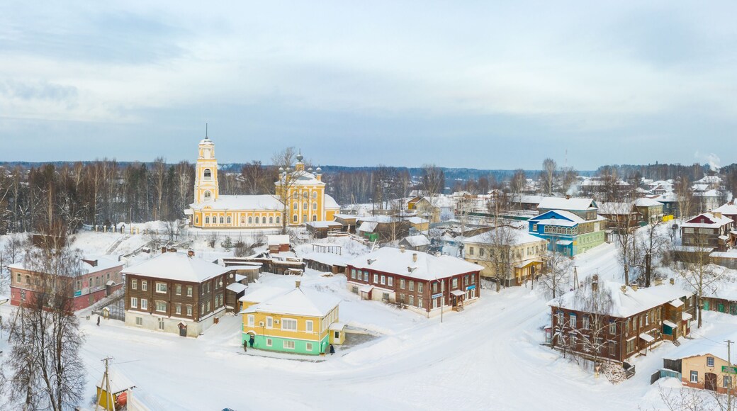 Panorama of a small city in the depths of Russia from a height. Orthodox churches and traditional old wooden houses, Kologriv in the Kostroma region and a winter view of the city