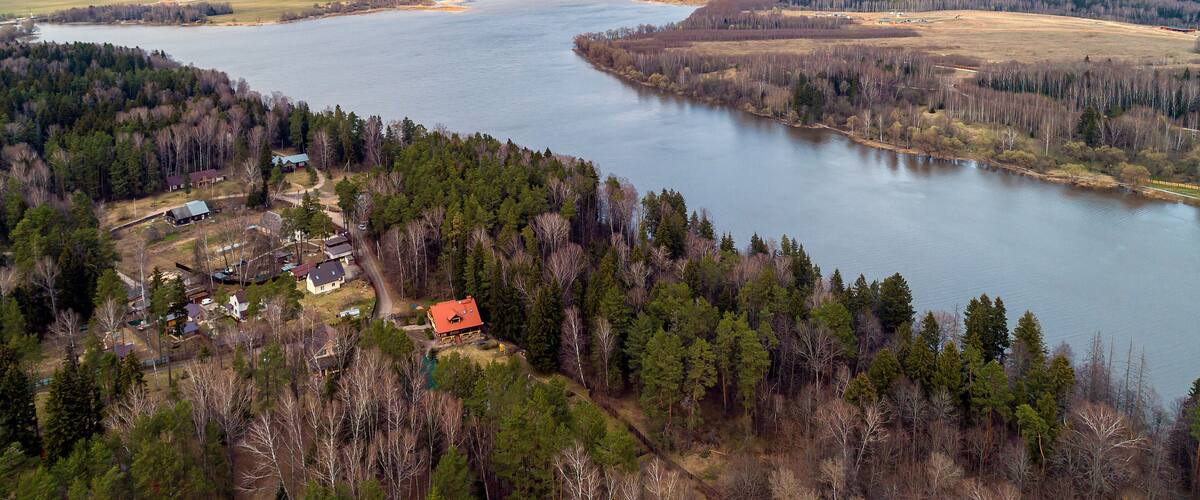 Ozerninskoe reservoir. artificial reservoir in Ruzsky urban district of Moscow region of Russia. Lake or river bank. Aerial view. Fields for crops in early spring.