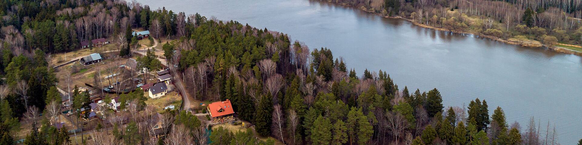 Ozerninskoe reservoir. artificial reservoir in Ruzsky urban district of Moscow region of Russia. Lake or river bank. Aerial view. Fields for crops in early spring.
