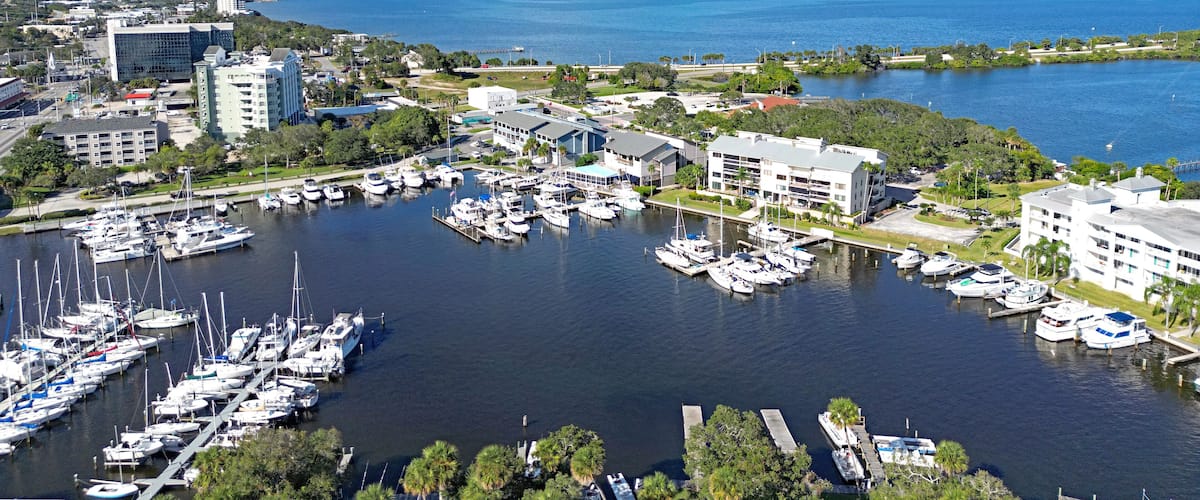 Aerial view of the yacht harbor basin with boats and nearby condos in historic downtown Melbourne along Florida's Space Coast in Brevard County