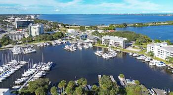 Aerial view of the yacht harbor basin with boats and nearby condos in historic downtown Melbourne along Florida's Space Coast in Brevard County
