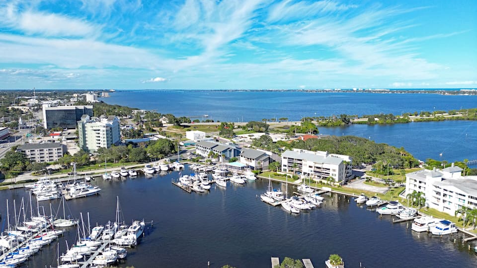 Aerial view of the yacht harbor basin with boats and nearby condos in historic downtown Melbourne along Florida's Space Coast in Brevard County