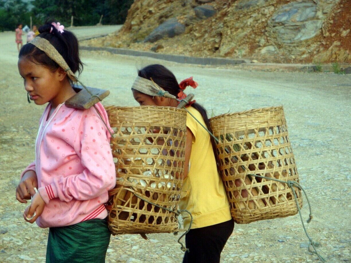 Ethnic girls selling vegetables in this little corner of the world